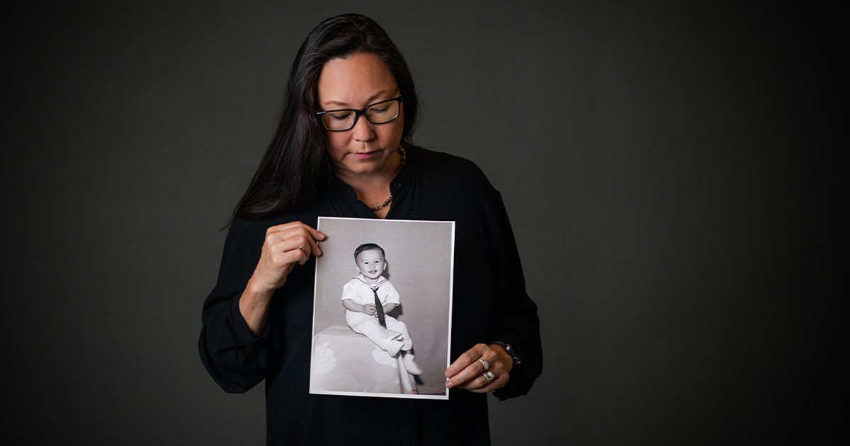 stephanie takaragawa holding black and white portrait of young boy