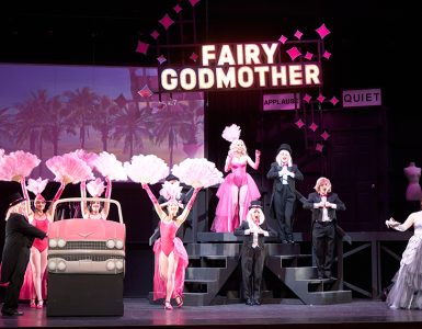 opera production with chorus girls and "fairy godmother' in neon lights