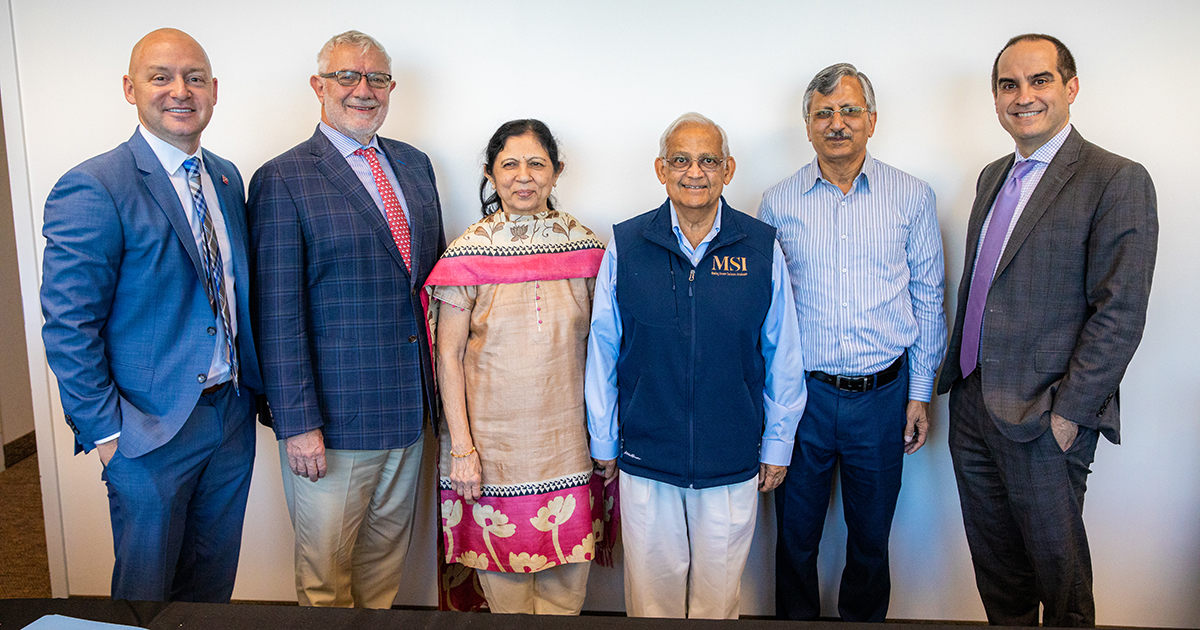 Chapman leadership with the Shah family during the gift agreement signing