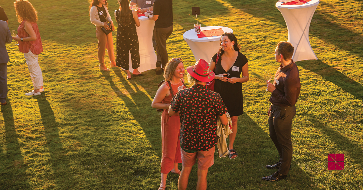 alumni talking on lawn