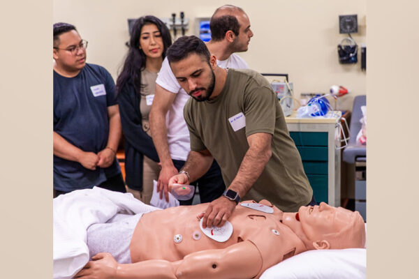 Students practice responding to a cardiac arrest on a mannequin at Chapman's Rinker Health Science Campus.