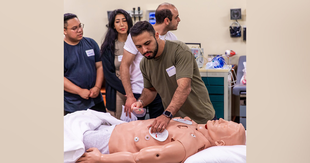 Students practice responding to a cardiac arrest on a mannequin at Chapman's Rinker Health Science Campus.