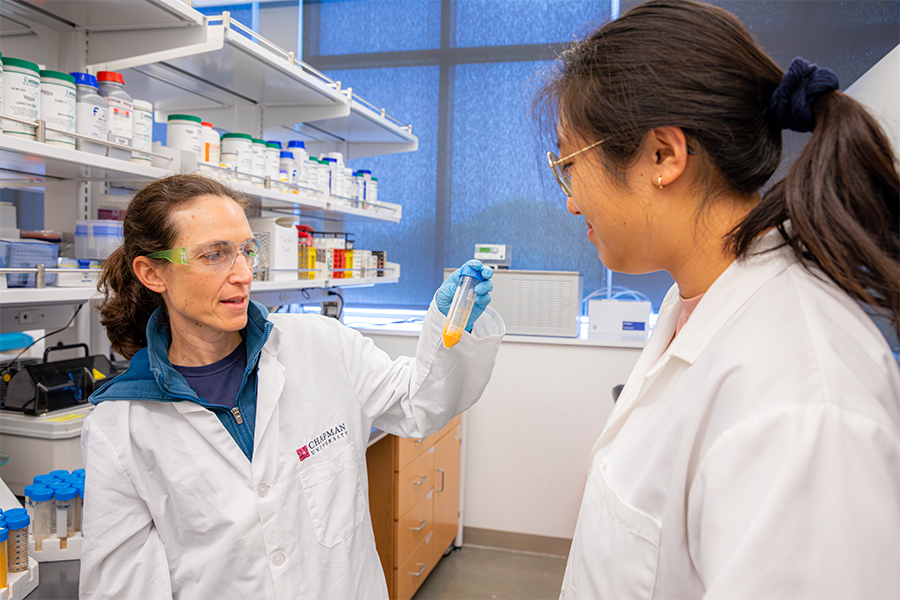 Professor Rosalee Hellberg, left, and student researcher Diane Kim working in a lab.