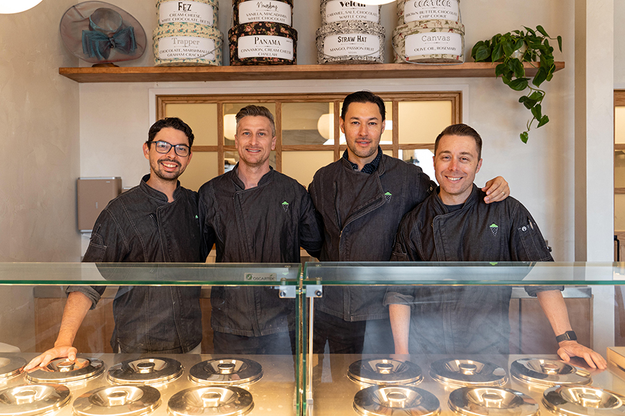 four men behind gelato display case