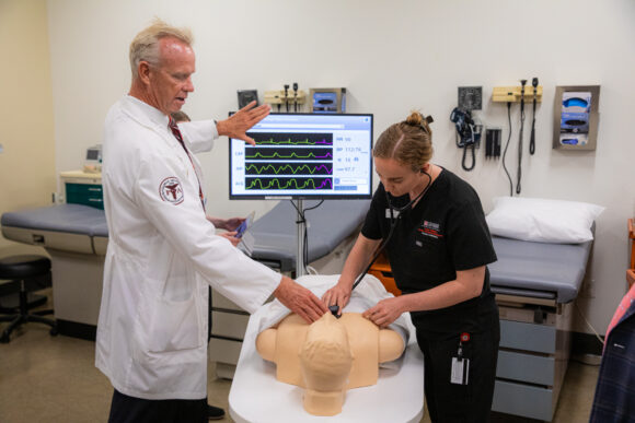 Mike Burney, left, director of Chapman's MMS PA Studies program, and a PA student do a demonstration in a lab at Rinker Campus.