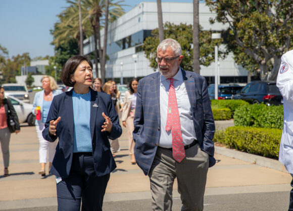 CalOptima Chief Operating Officer Yunkyung Kim walks with Chapman President Daniele C. Struppa at Rinker Campus.