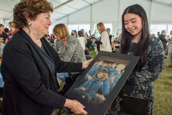 eva brettier and female student look at a painting