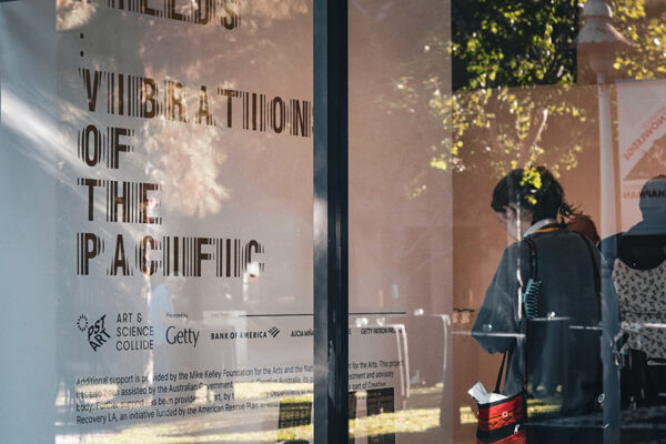 front window view of guggenheim gallery with Energry Fields: Vibrations of the Pacific sign