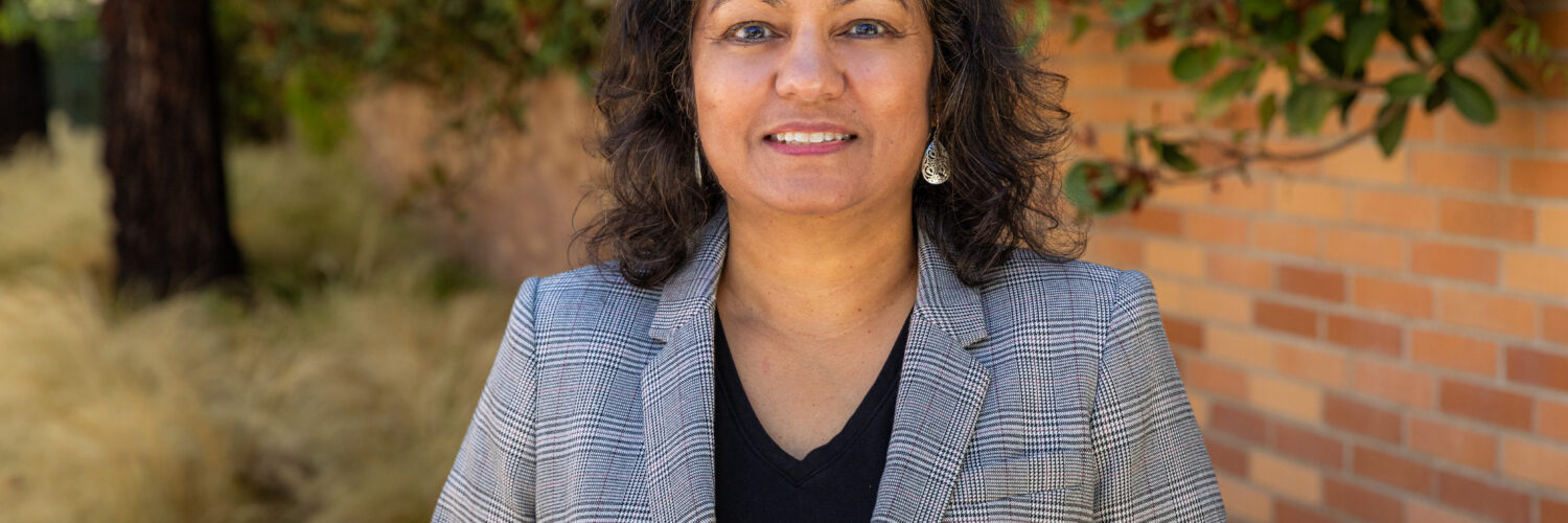 Associate Professor Dr. Charu Sinha, newly appointed Academic Director of Chapman University's Master of Science in Business Analytics program, stands on campus following the program’s official announcement.