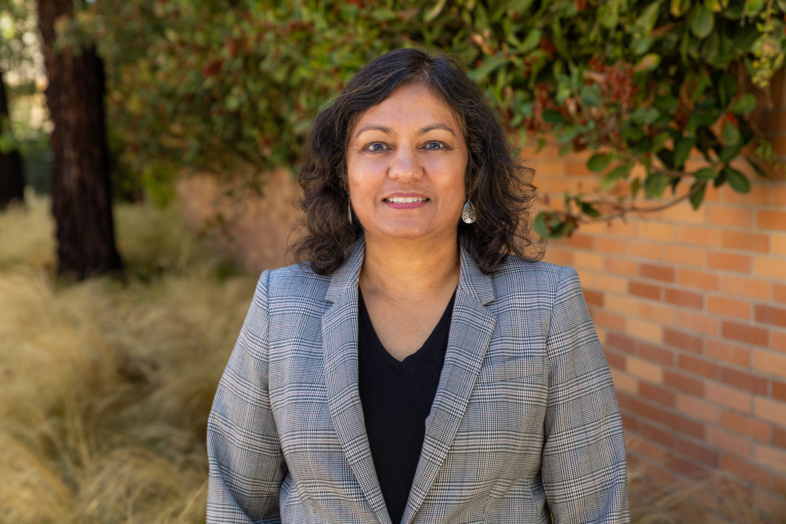 Associate Professor Dr. Charu Sinha, newly appointed Academic Director of Chapman University's Master of Science in Business Analytics program, stands on campus following the program’s official announcement.