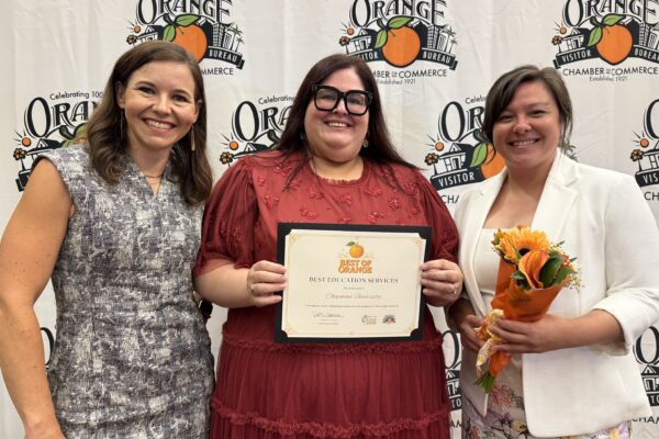 Community Relations team celebrates Best of Orange Award.
