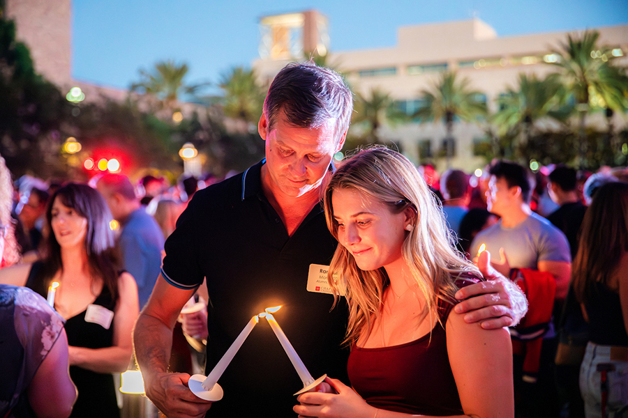 father and daughter lighting candles