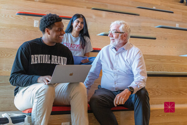 President Daniele Struppa talks with two Chapman students