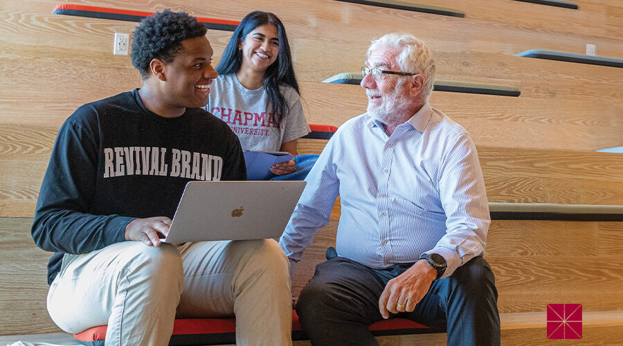 President Daniele Struppa talks with two Chapman students