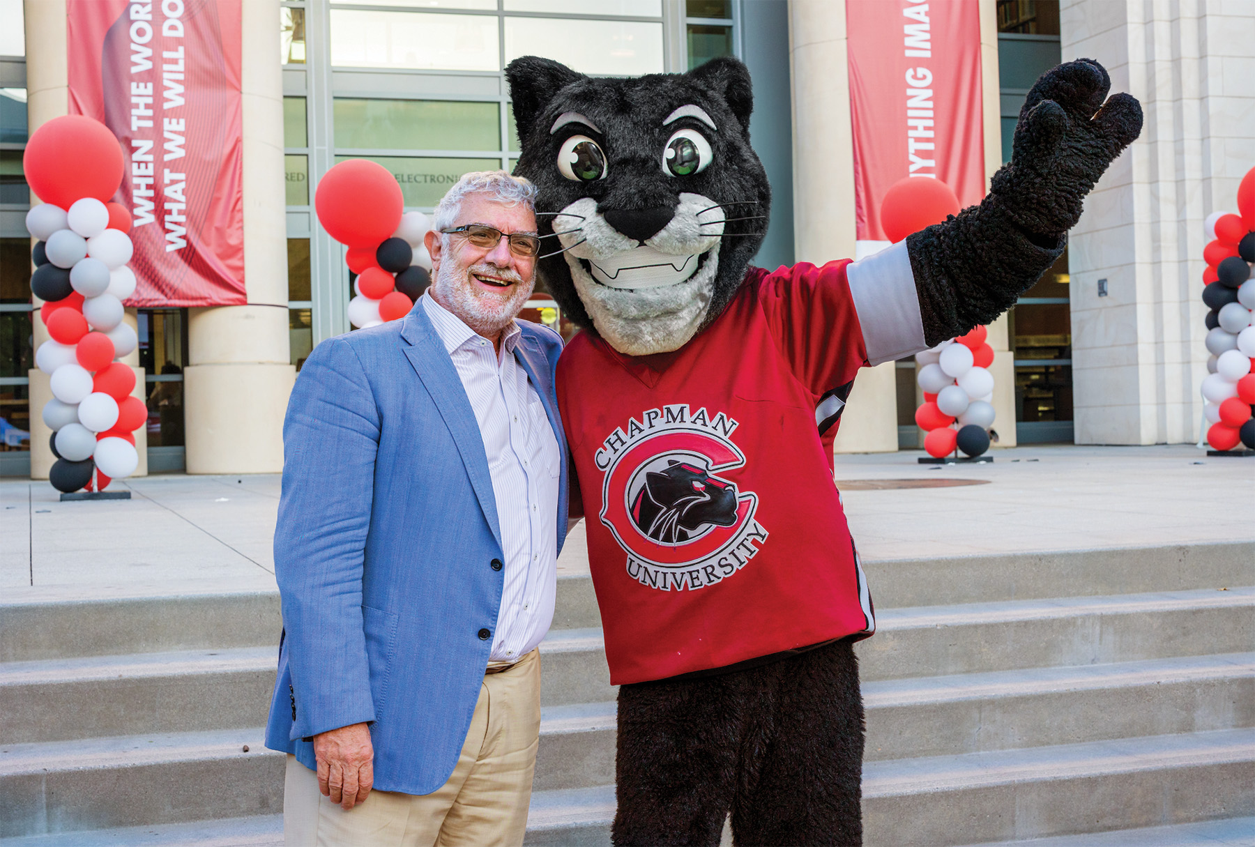 Daniele Struppa and Pete the Panther pose for a photo.