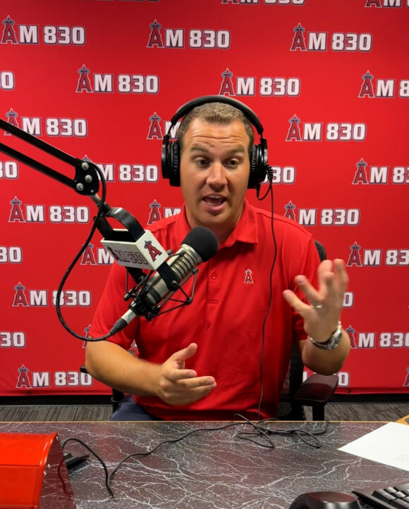 Trent Rush sits in the Angeles Radio studio and gives fans an update over the radio about the Angels and Dodgers games.