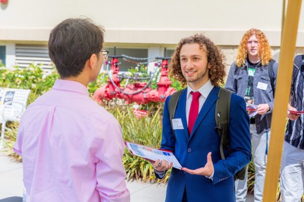 young man in suit talking to recruiter