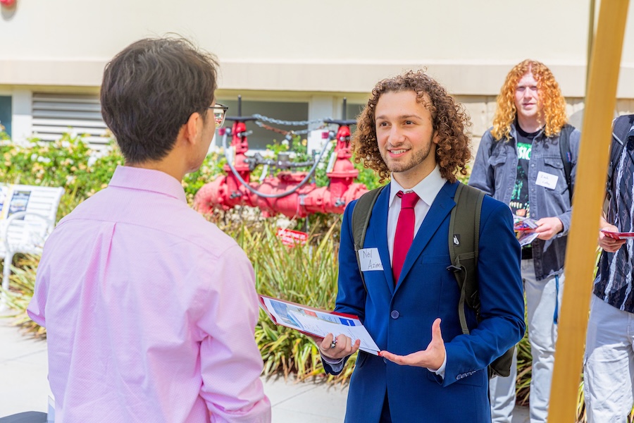 young man in suit talking to recruiter