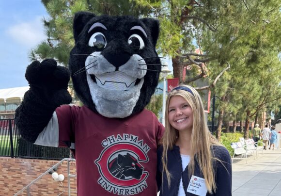 Prospective student Charlotte Lewis is all smiles with Pete the Panther during the 2025 Fall Open House