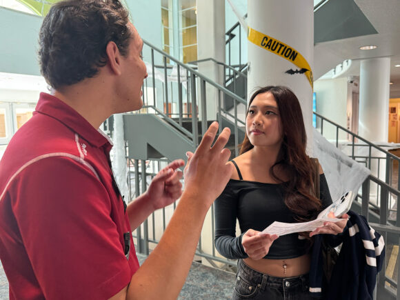 Shevalonica Sastro learns more about dorm life from a                               member of the Resident Life staff.