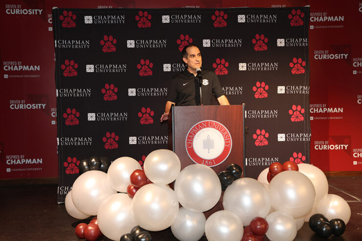 parlow on a podium surrounded by balloons