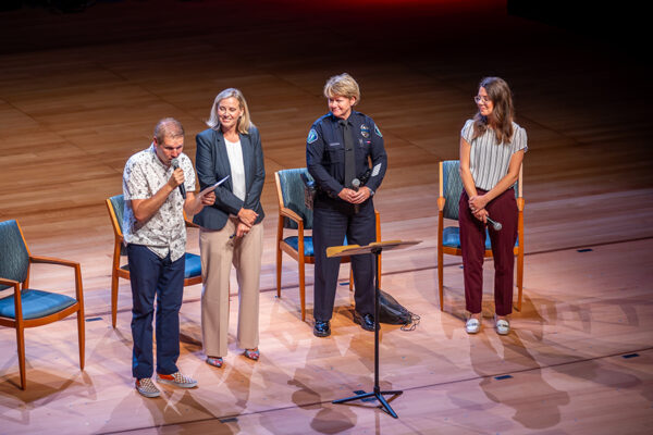 four people present on stage