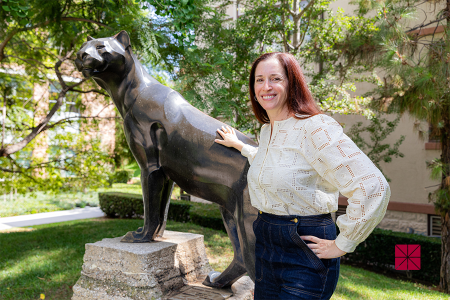 Vikki Katz posing with panther statue