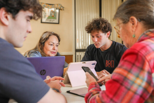 Members of Beta Theta Pi lending their tech skills, and their time to local seniors.