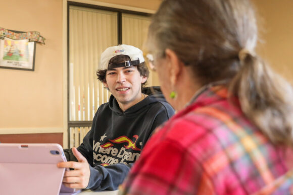 Senior Lyle Diaz helping a senior stay connected.
