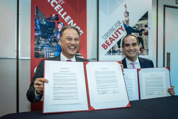 Chapman University President Matt Parlow and Marymount Education Foundation Chair of Board Rick Elder sign partnership agreement.