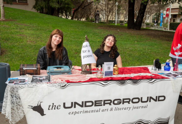 The Underground literary club invites passersby to “ask for a poem” at the campus fair.