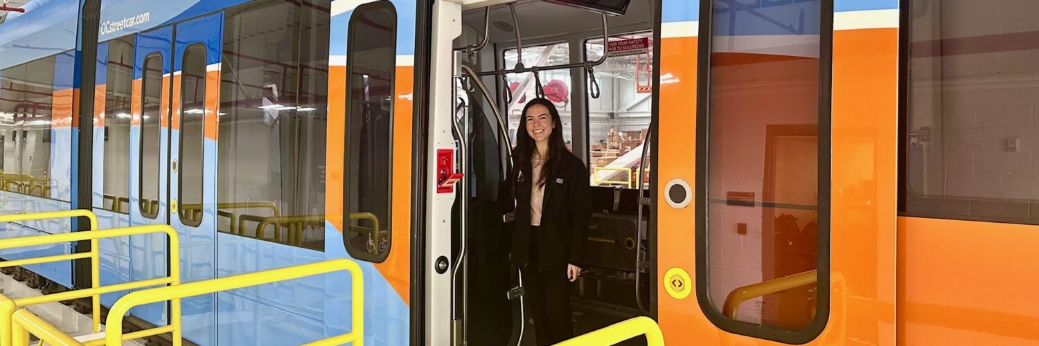 Megan Abbas stands in an OC Streetcar.