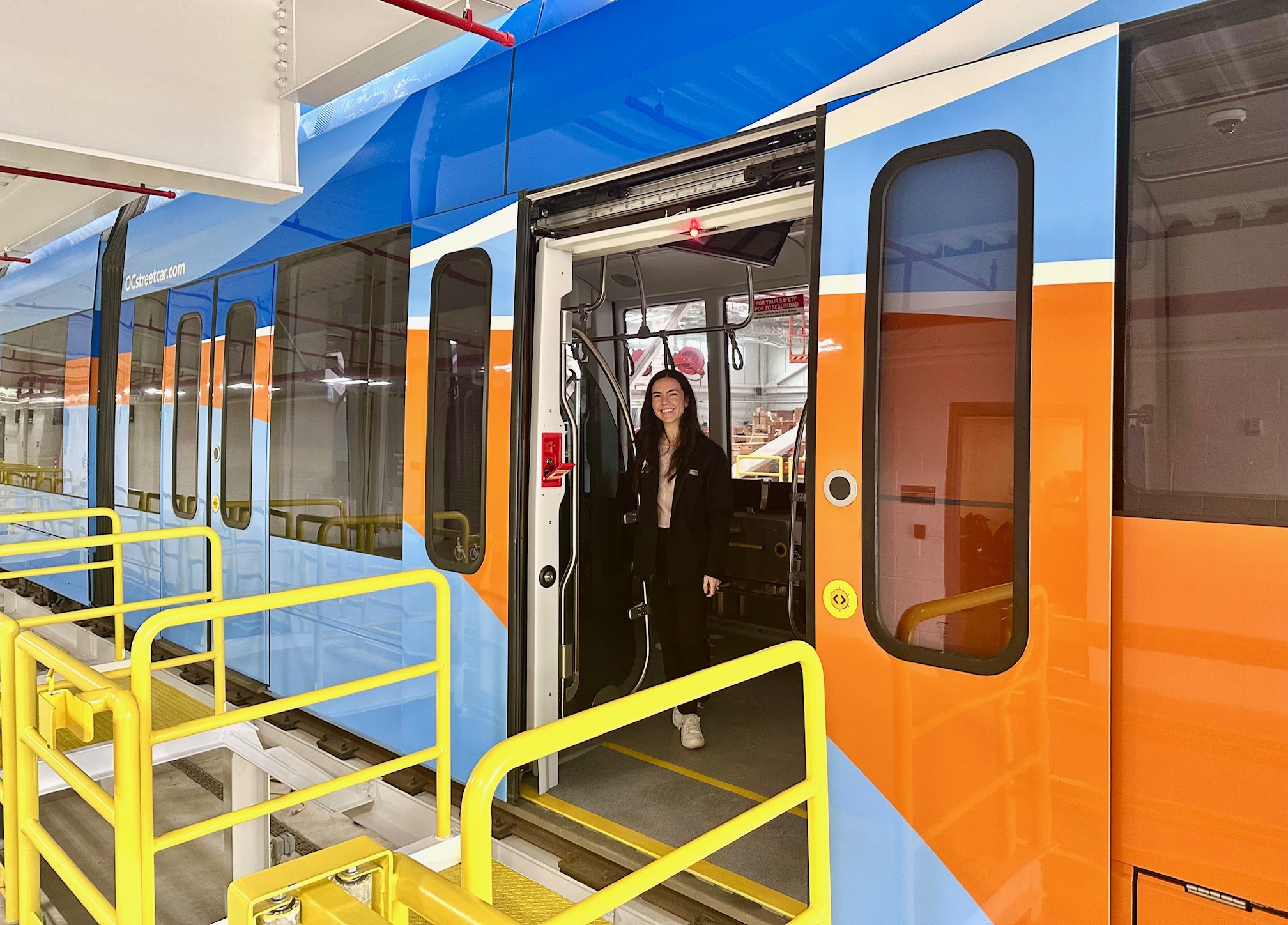 Megan Abbas stands in an OC Streetcar.