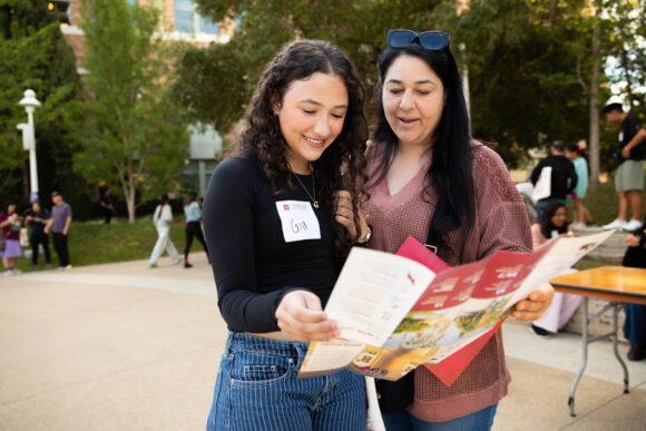 An admitted student and a relative look at a map of Chapman University during Preview Day.