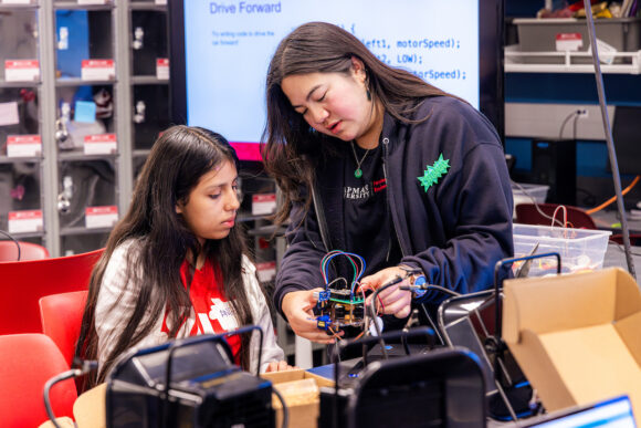 two girls working on electronics