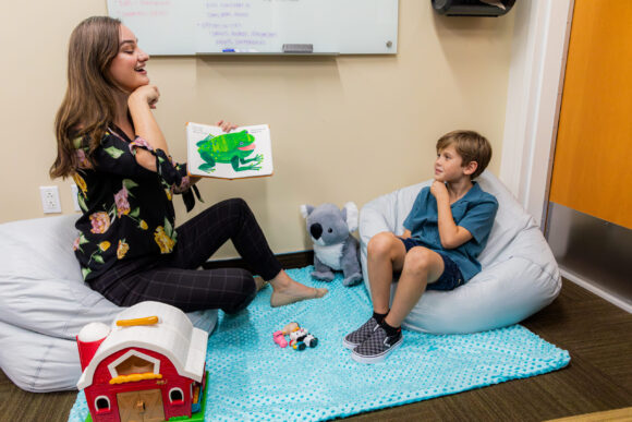 A graduate student meets with a young patient as part of their practicum.