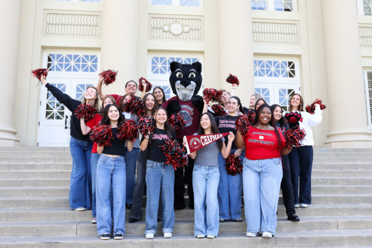 Students and Pete the Panther pose in front of Chapman's campus.