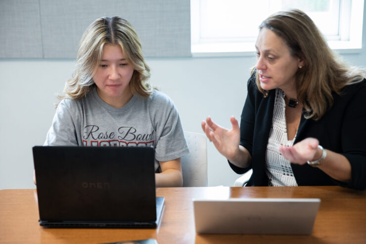 Karen Snedker, Ph.D., assistant professor of sociology, works with a student during the Henley Lab’s Summer Pre-College Research Experience.