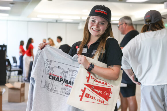Isabel “Isa” Gomez displays a Chapman sweatshirt and canvas tote bag at Orientation check-in.