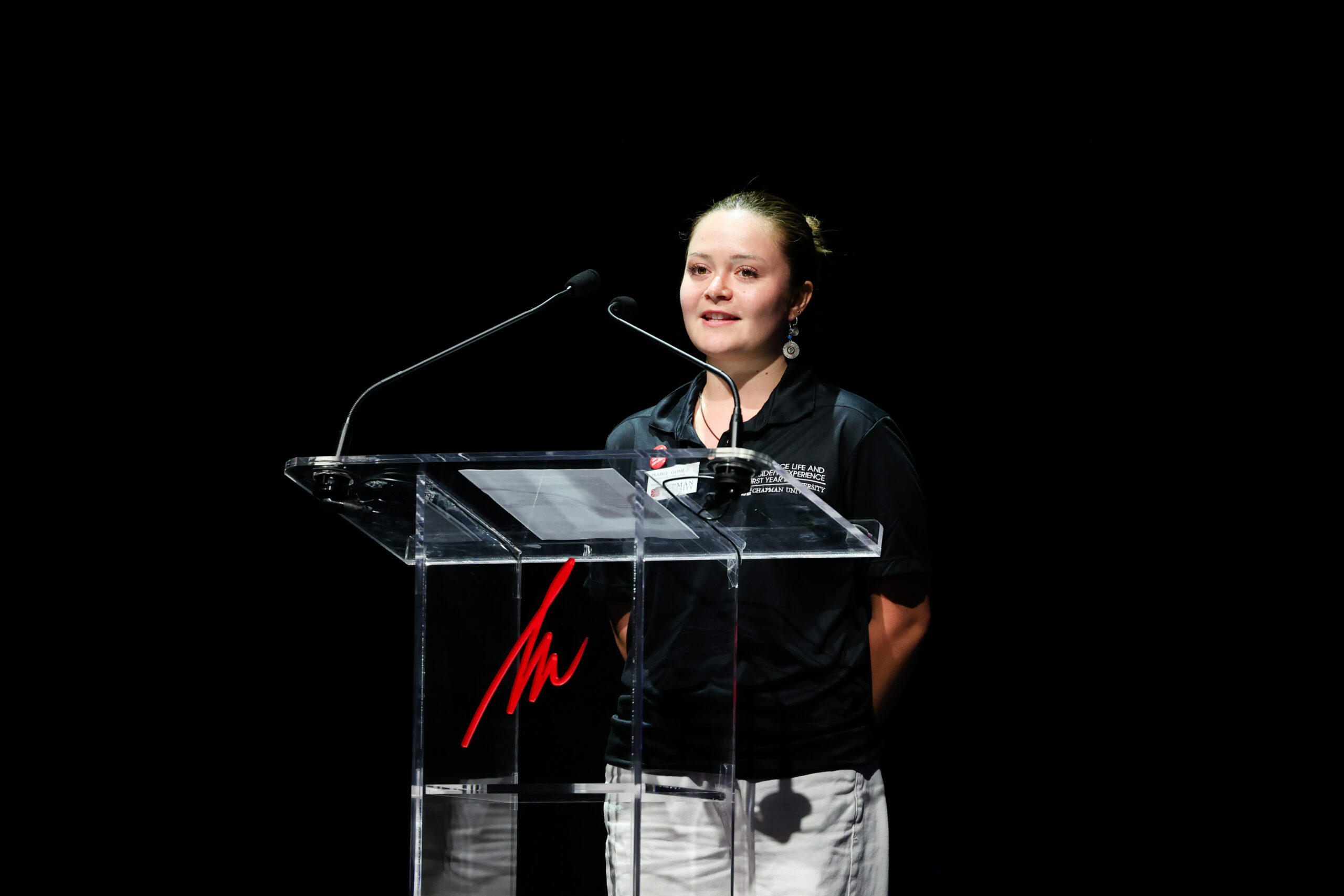 Isabel “Isa” Gomez speaks from a lectern onstage during the Becoming Panthers program at Musco Center for the Arts.