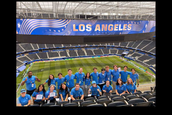 Chapman student interns post in SoFi Stadium