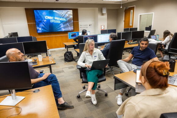 Chapman University MBA students and faculty members in a classroom discussion about business leadership and career development