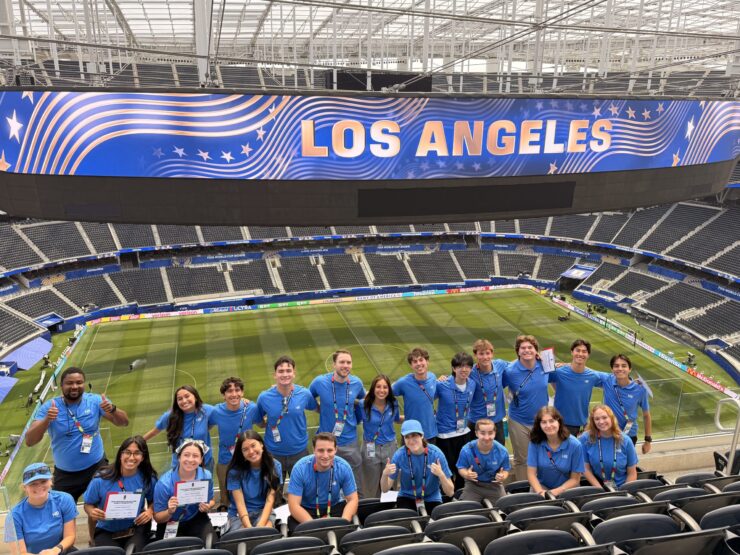 Chapman student interns post in SoFi Stadium