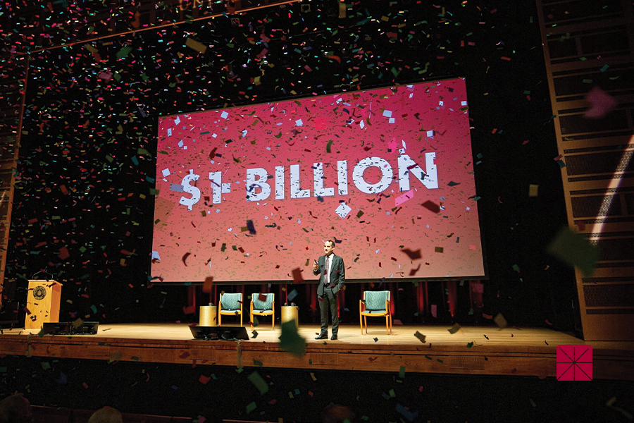 Chapman University President Matt Parlow stands on stage at Musco Center for the Arts as confetti falls in celebration of Chapman's endowment reaching $1 billioin.