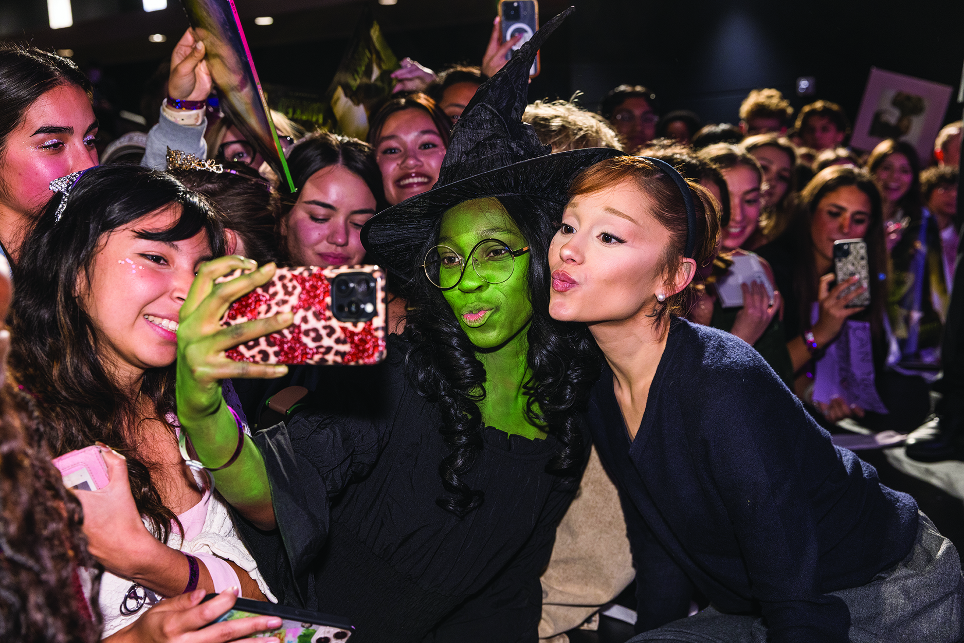 Singer and Wicked star Ariana Grande poses with a costume contest winner dressed as Elphaba at a Dodge College master class.