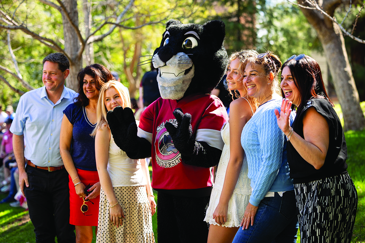 A Chapman family paused for a photo with Pete the Panther during the Parent Spring Summit.
