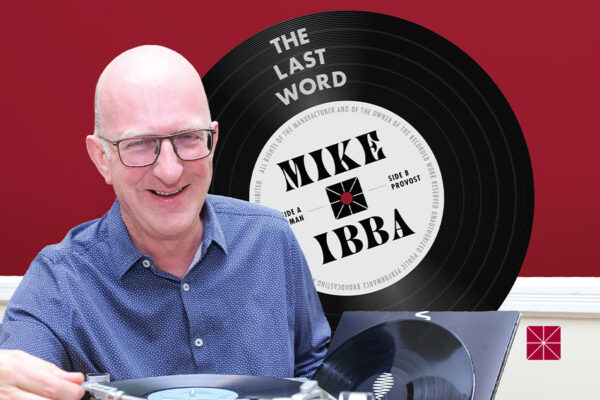 Mike Ibba holds the needle of a record player.